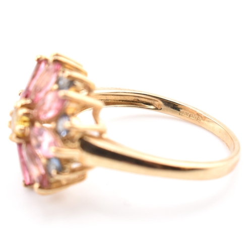 78 - A hallmarked 9ct gold, sapphire and tourmaline flower cluster ring. The 9ct yellow gold ring having ... 