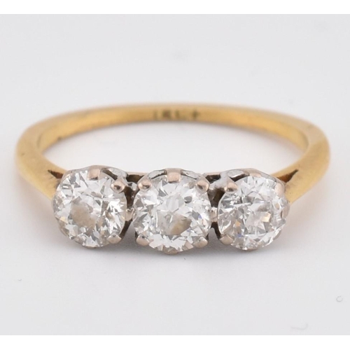 81 - An 18ct gold and diamond three stone ring. The yellow gold ring set with three round brilliant cut d... 