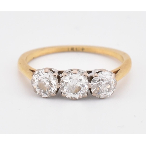 81 - An 18ct gold and diamond three stone ring. The yellow gold ring set with three round brilliant cut d... 