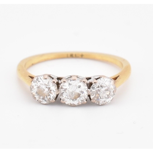 81 - An 18ct gold and diamond three stone ring. The yellow gold ring set with three round brilliant cut d... 