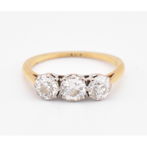 81 - An 18ct gold and diamond three stone ring. The yellow gold ring set with three round brilliant cut d... 