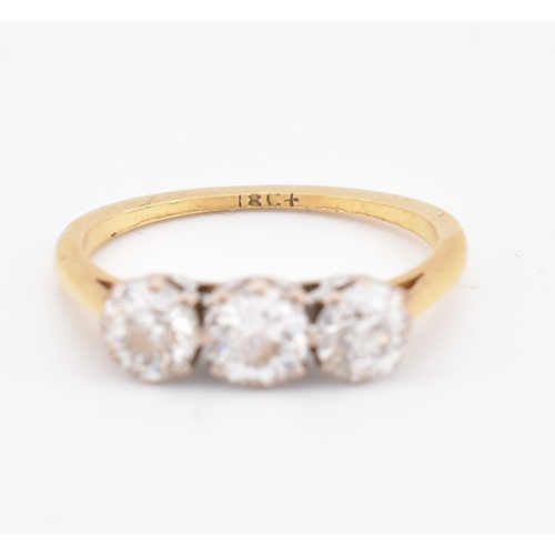 81 - An 18ct gold and diamond three stone ring. The yellow gold ring set with three round brilliant cut d... 