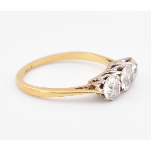 81 - An 18ct gold and diamond three stone ring. The yellow gold ring set with three round brilliant cut d... 