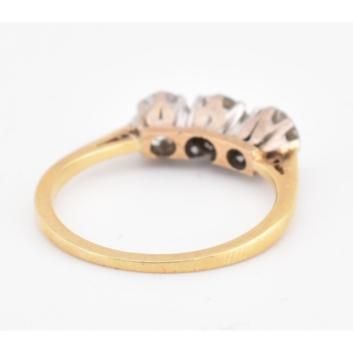 81 - An 18ct gold and diamond three stone ring. The yellow gold ring set with three round brilliant cut d... 