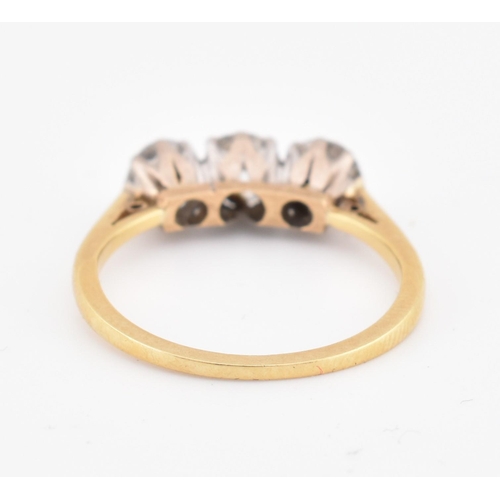 81 - An 18ct gold and diamond three stone ring. The yellow gold ring set with three round brilliant cut d... 