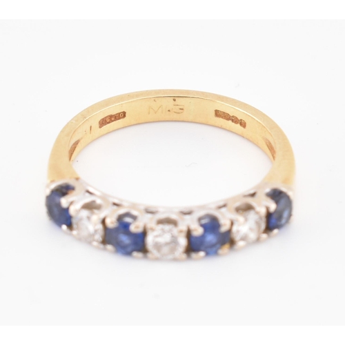 85 - A hallmarked 18ct gold, sapphire and diamond half hoop ring. The 18ct yellow gold ring set with a si... 