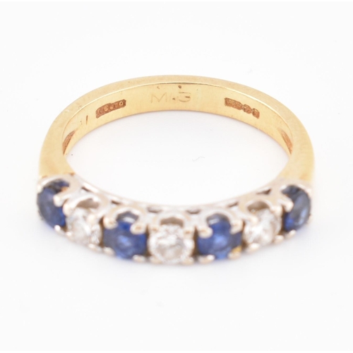 85 - A hallmarked 18ct gold, sapphire and diamond half hoop ring. The 18ct yellow gold ring set with a si... 