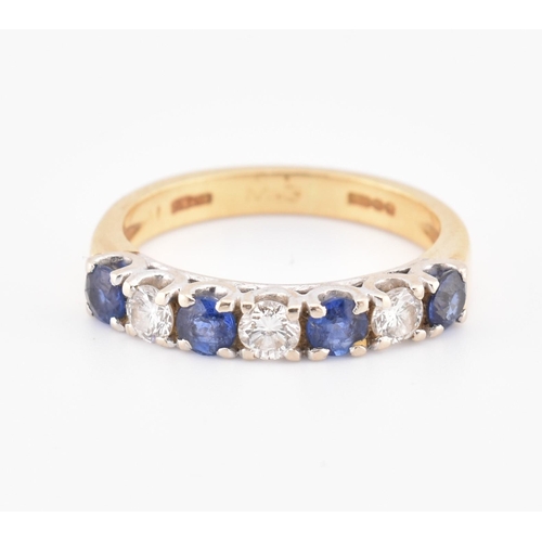 85 - A hallmarked 18ct gold, sapphire and diamond half hoop ring. The 18ct yellow gold ring set with a si... 