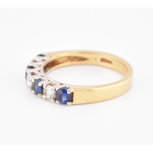 85 - A hallmarked 18ct gold, sapphire and diamond half hoop ring. The 18ct yellow gold ring set with a si... 