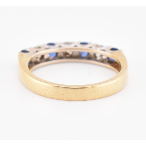 85 - A hallmarked 18ct gold, sapphire and diamond half hoop ring. The 18ct yellow gold ring set with a si... 