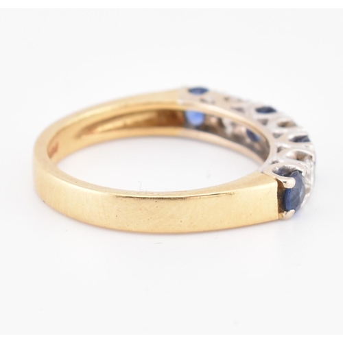 85 - A hallmarked 18ct gold, sapphire and diamond half hoop ring. The 18ct yellow gold ring set with a si... 