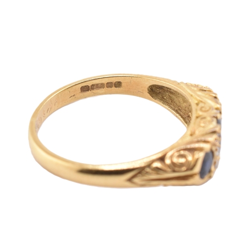 86 - A hallmarked 18ct gold sapphire and diamond three stone gypsy ring. The 18ct yellow gold ring having... 