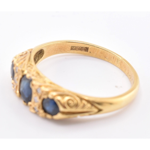 86 - A hallmarked 18ct gold sapphire and diamond three stone gypsy ring. The 18ct yellow gold ring having... 