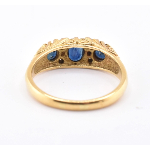 86 - A hallmarked 18ct gold sapphire and diamond three stone gypsy ring. The 18ct yellow gold ring having... 