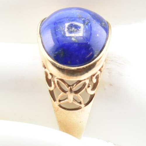 88 - A hallmarked 9ct gold and lapis lazuli dome ring. The 9ct yellow gold ring having an oval lapis lazu... 