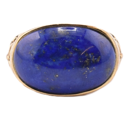 88 - A hallmarked 9ct gold and lapis lazuli dome ring. The 9ct yellow gold ring having an oval lapis lazu... 