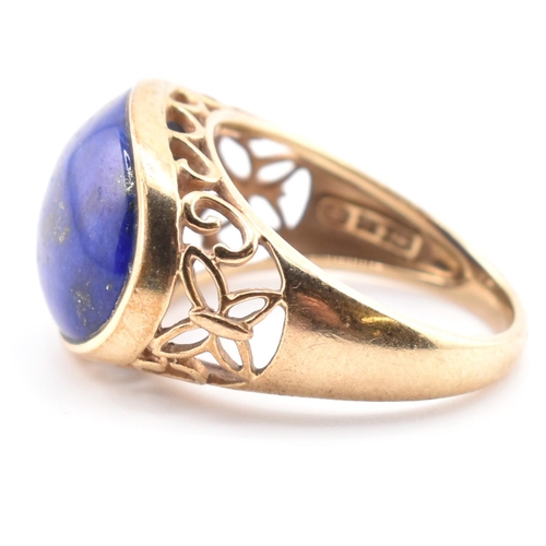 88 - A hallmarked 9ct gold and lapis lazuli dome ring. The 9ct yellow gold ring having an oval lapis lazu... 