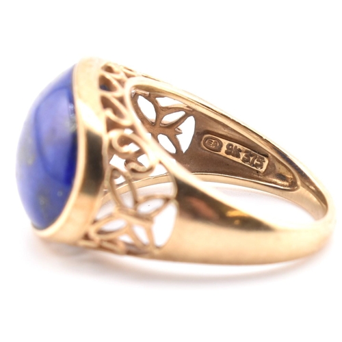 88 - A hallmarked 9ct gold and lapis lazuli dome ring. The 9ct yellow gold ring having an oval lapis lazu... 