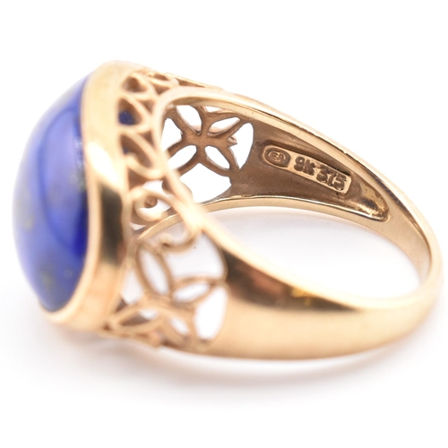 88 - A hallmarked 9ct gold and lapis lazuli dome ring. The 9ct yellow gold ring having an oval lapis lazu... 