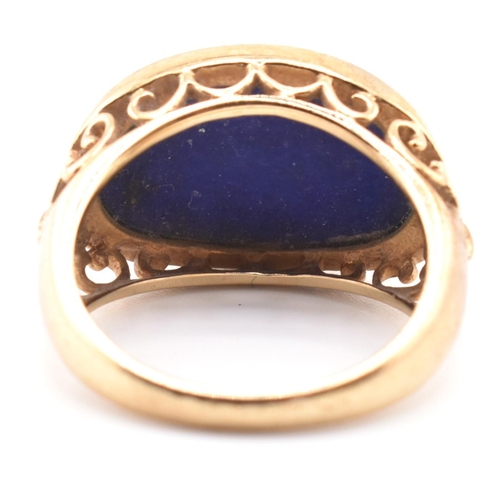 88 - A hallmarked 9ct gold and lapis lazuli dome ring. The 9ct yellow gold ring having an oval lapis lazu... 