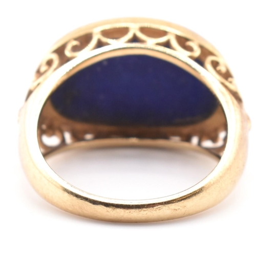 88 - A hallmarked 9ct gold and lapis lazuli dome ring. The 9ct yellow gold ring having an oval lapis lazu... 