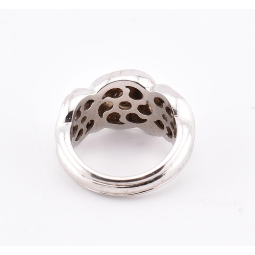 97 - An 18ct white gold Boucheron ring. The 18ct white gold Boucheron ring having a swirled design to tap... 