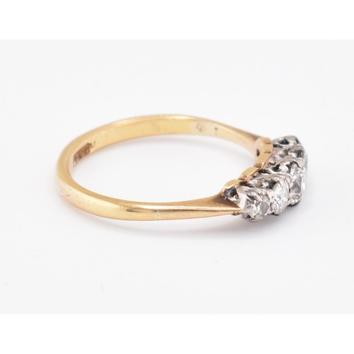 99 - An 18ct gold and diamond five stone ring. The 18ct yellow gold ring set with five claw set graduatin... 