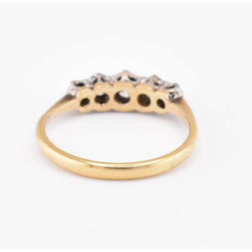 99 - An 18ct gold and diamond five stone ring. The 18ct yellow gold ring set with five claw set graduatin... 