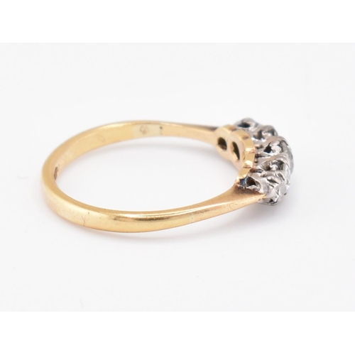 99 - An 18ct gold and diamond five stone ring. The 18ct yellow gold ring set with five claw set graduatin... 