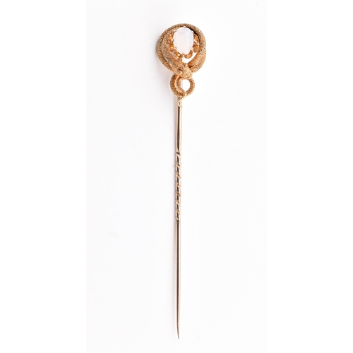 41 - A Victorian gold and opal snake stick pin. The Victorian yellow gold stick pin having a claw set opa... 