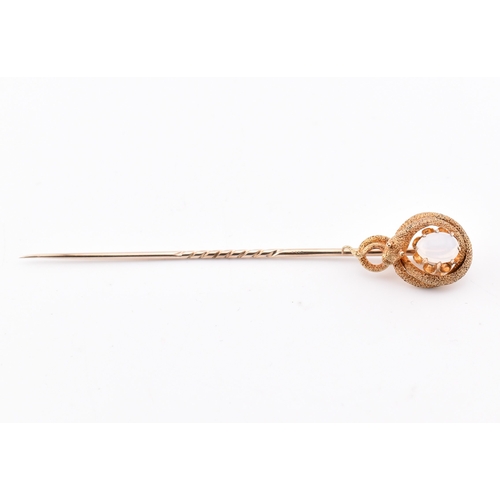 41 - A Victorian gold and opal snake stick pin. The Victorian yellow gold stick pin having a claw set opa... 