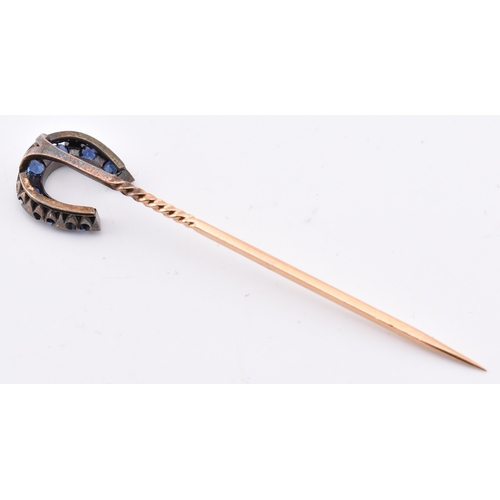 51 - A 19th century sapphire and diamond horseshoe stick pin. The antique stick pin having a horseshoe se... 