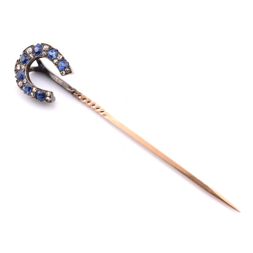 51 - A 19th century sapphire and diamond horseshoe stick pin. The antique stick pin having a horseshoe se... 