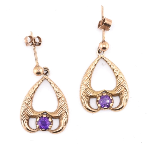 52 - A pair of hallmarked 9ct gold and purple stone pendant earrings. The 9ct yellow gold pendant earring... 