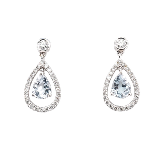 92 - A pair of hallmarked 18ct gold, aquamarine and diamond pendant earrings. The 18ct white gold earring... 