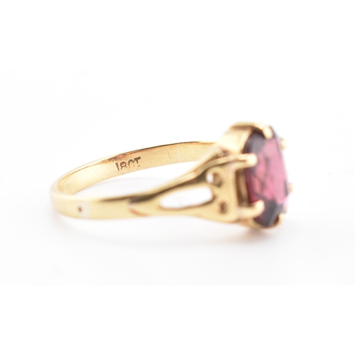 157 - An 18ct gold and garnet ring. The 18ct yellow gold ring set with a six-claw set single fancy cut gar... 