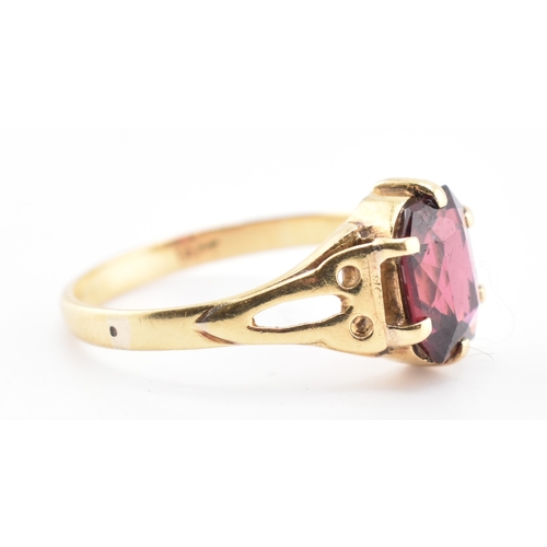 157 - An 18ct gold and garnet ring. The 18ct yellow gold ring set with a six-claw set single fancy cut gar... 