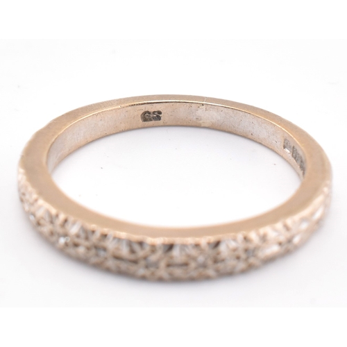 89 - A hallmarked 18ct gold and diamond half hoop ring. The 18ct white gold ring set with six illusion se... 