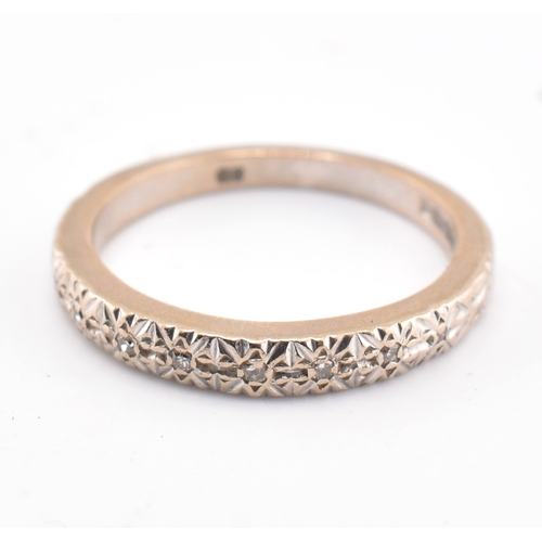 89 - A hallmarked 18ct gold and diamond half hoop ring. The 18ct white gold ring set with six illusion se... 