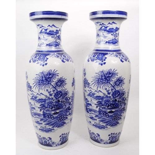 102 - A pair of contemporary Chinese blue and white ceramic vases. The transfer print depicts an Asian Chi... 