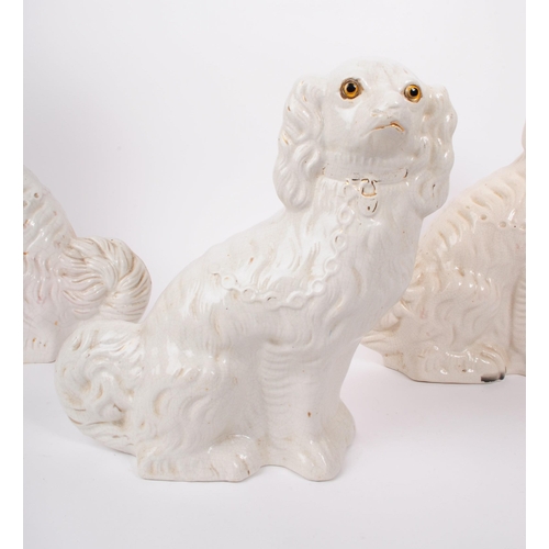 108 - A pair of 19th century Victorian fireside mantel Staffordshire dogs. In a seated position with paint... 