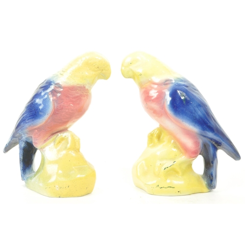 126 - A pair of 19th century Victorian ceramic bird parrot figurines, with a yellow, pink and blue glaze. ... 