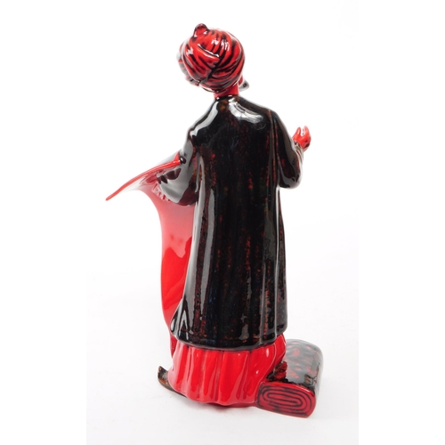 130 - Royal Doulton - 1990 porcelain Flambe 'The Carpet Seller' HN 2776 figurine. Featured in a black and ... 