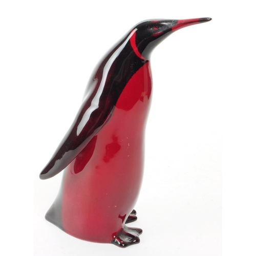 137 - Royal Doulton - Early 20th century porcelain Flambe Emporer Penguin figure. Featured in a red and bl... 