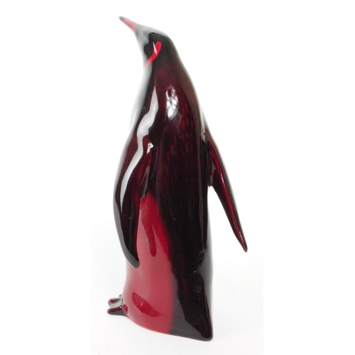 137 - Royal Doulton - Early 20th century porcelain Flambe Emporer Penguin figure. Featured in a red and bl... 