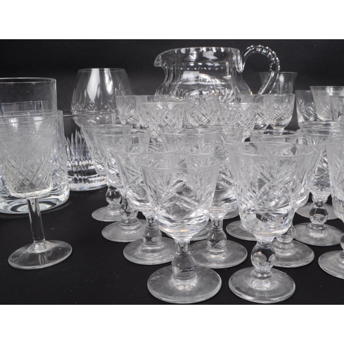 15 - A large collection of 20th century crystal cut drinking glasses, some examples by Thomas Webb, Stuar... 