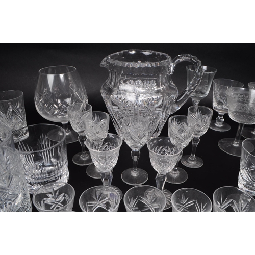 15 - A large collection of 20th century crystal cut drinking glasses, some examples by Thomas Webb, Stuar... 