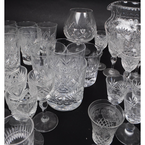 15 - A large collection of 20th century crystal cut drinking glasses, some examples by Thomas Webb, Stuar... 