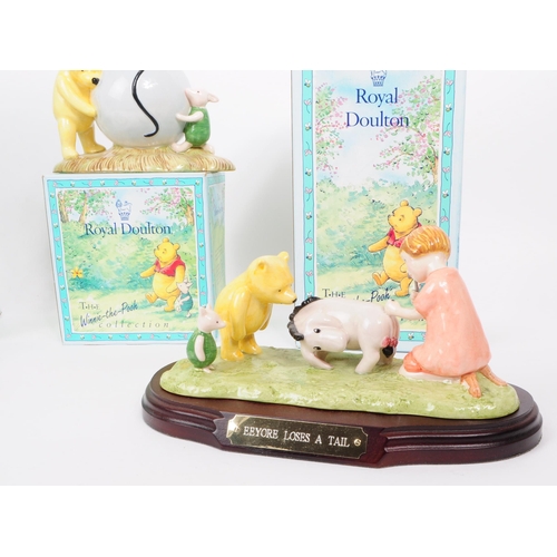 153 - Royal Doulton - Three late 20th century bone china Winnie The Pooh figures. Comprised of Pooh's Blue... 