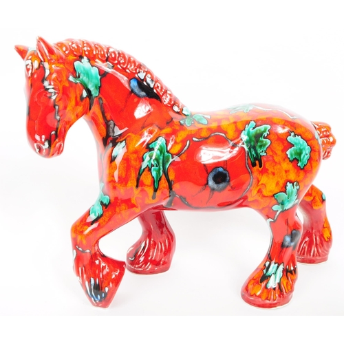 168 - A vintage mid 20th century Anita Harris Pottery ceramic horse, alongside other ceramic pieces. The c... 